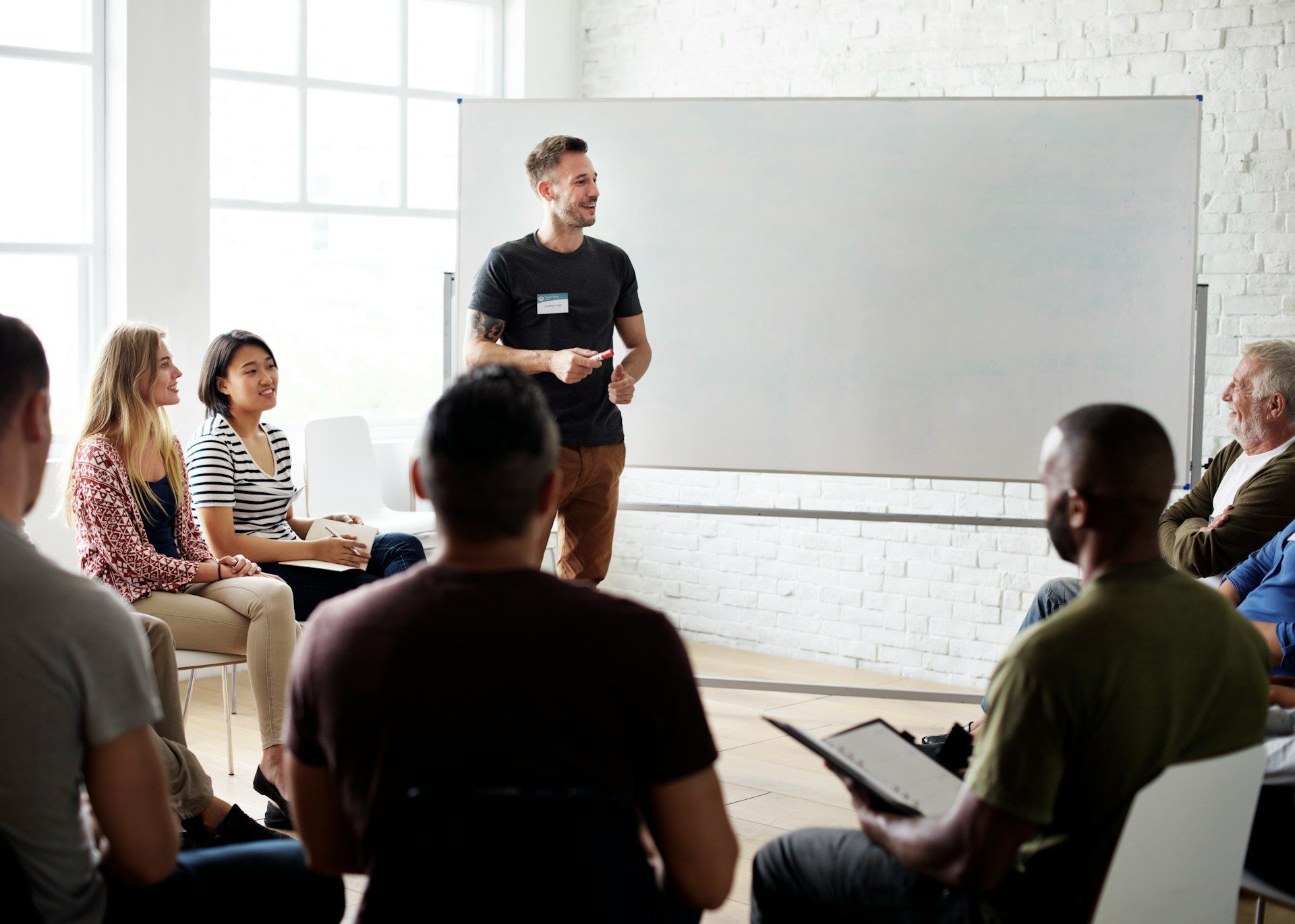 a group of colleagues sitting in a conference room taking part in an indoor corporate event