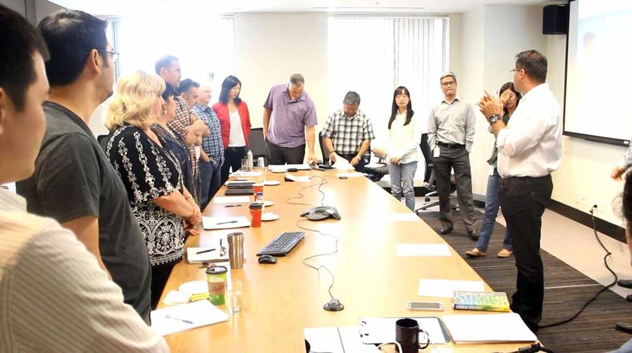 a team of employees at a conference practical time management training for administrative professionals day