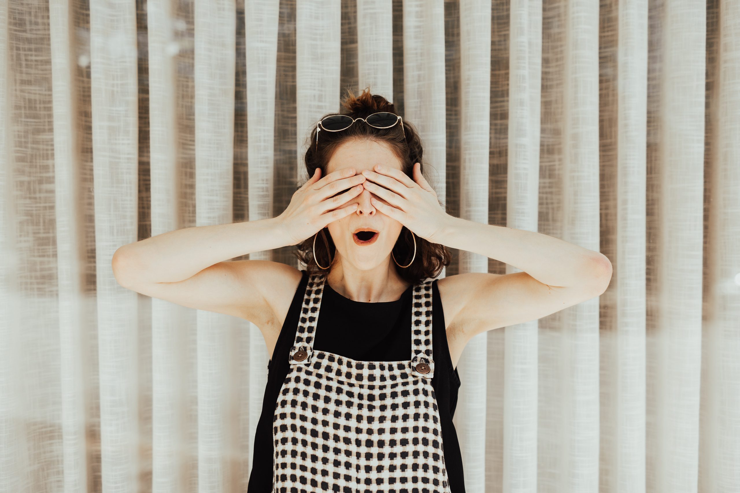 Weird team building questions section image with lady covering her eyes