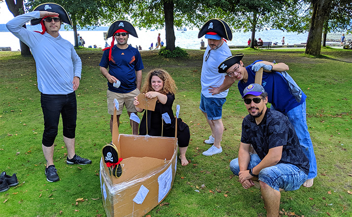 a team of colleagues doing a cardboard boat building challenge