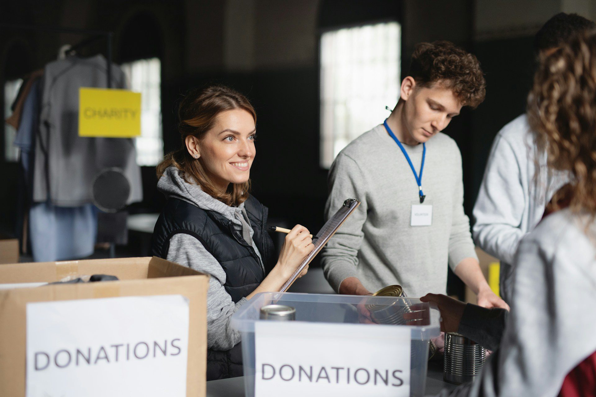 two colleagues collecting donations while doing a charitable corporate event with their team