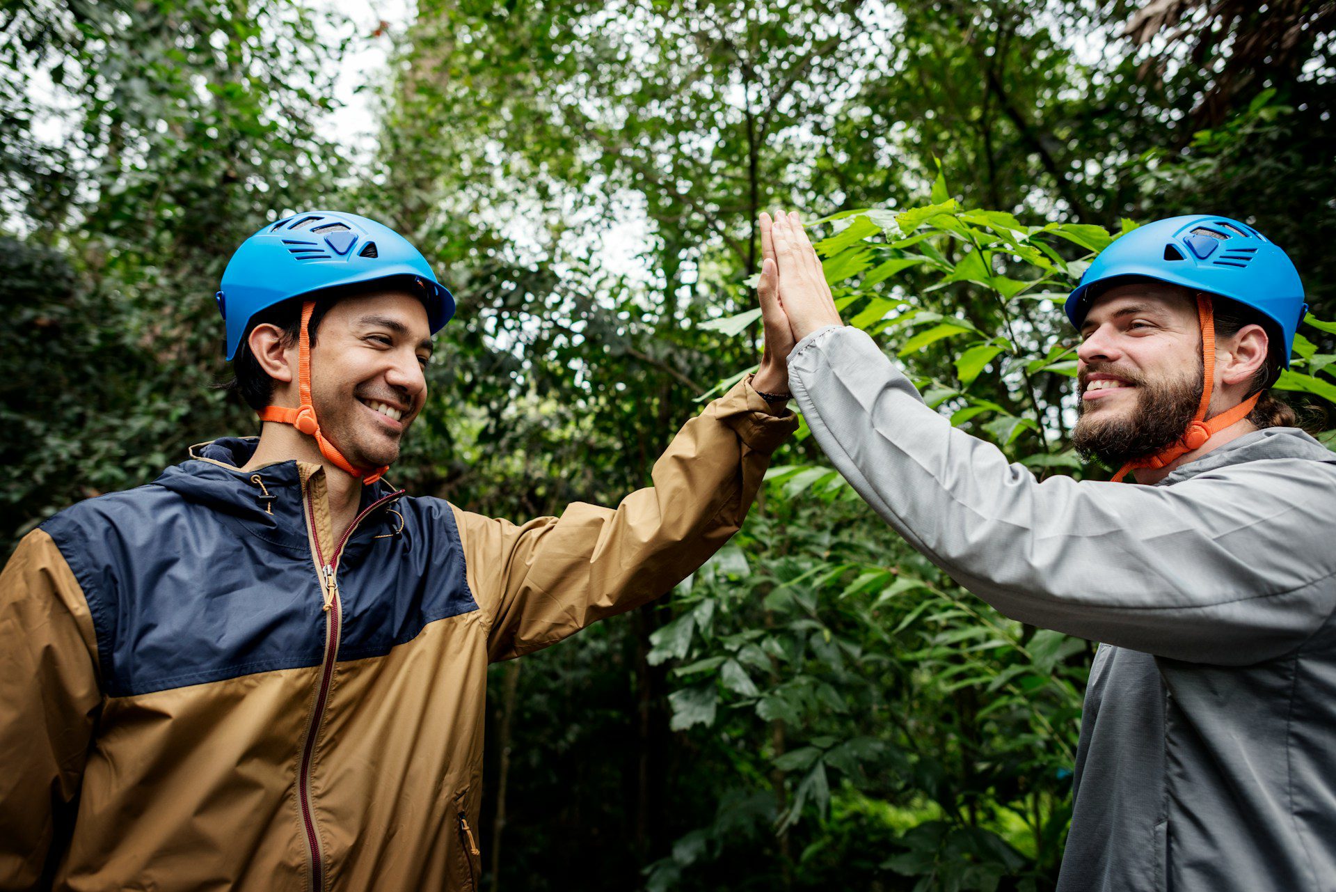 two colleagues giving a high five at an outdoor corporate event